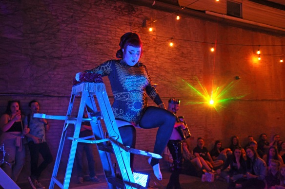 Allentown Night Market founder Kelly Braden climbs a sword ladder during a performance in June, 2022.